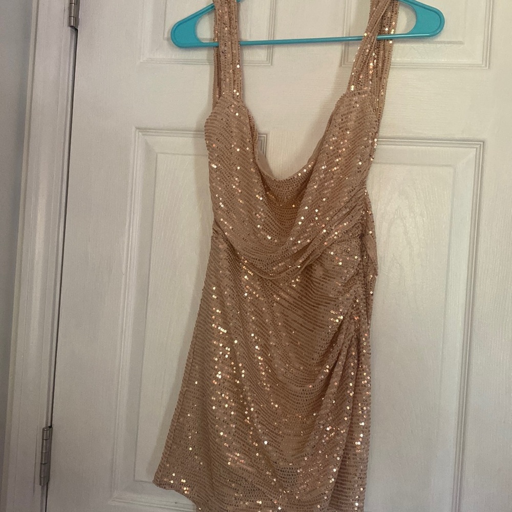 This dress is more rose gold in person. It is a medium from Lucy In The Sky.